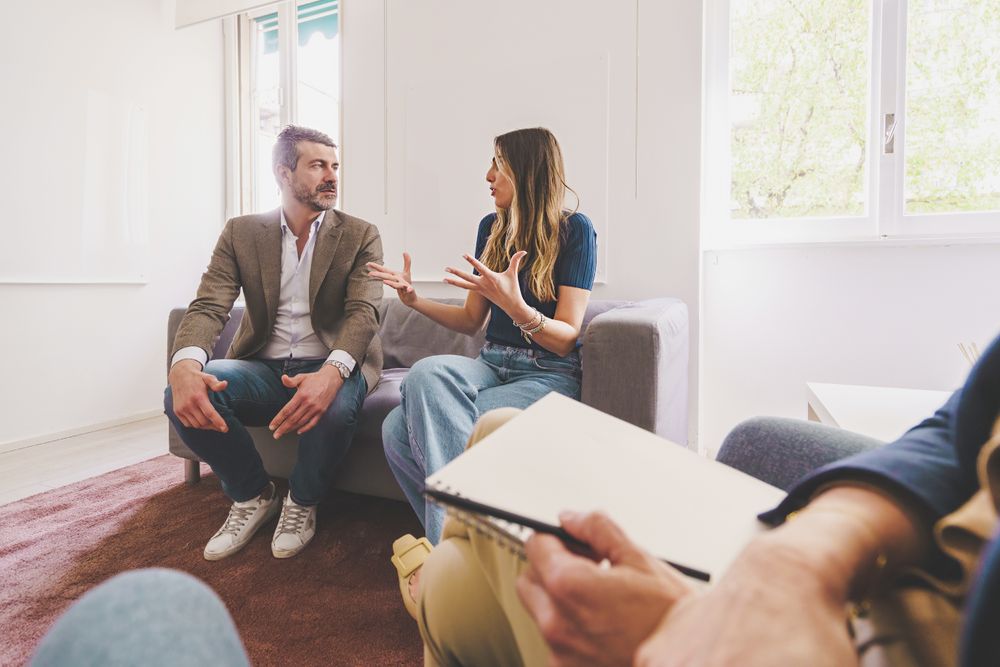 A man and woman discuss their issues during a therapy session