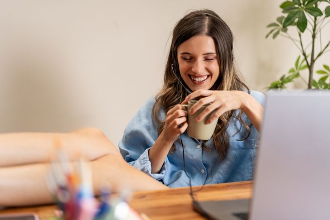 Woman Relaxing with Coffee During Remote Work - Comfortable Home Office