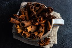 Top view of cinnamon sticks and anise star in mug