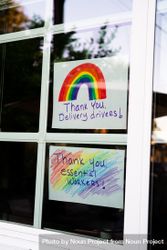 Hand lettered signs taped to home windows thanking essential workers during quarantine 56Gpl4
