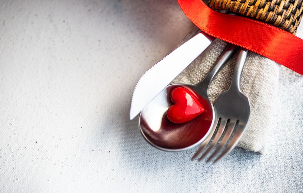 St Valentine day table setting with red heart and napkin ring