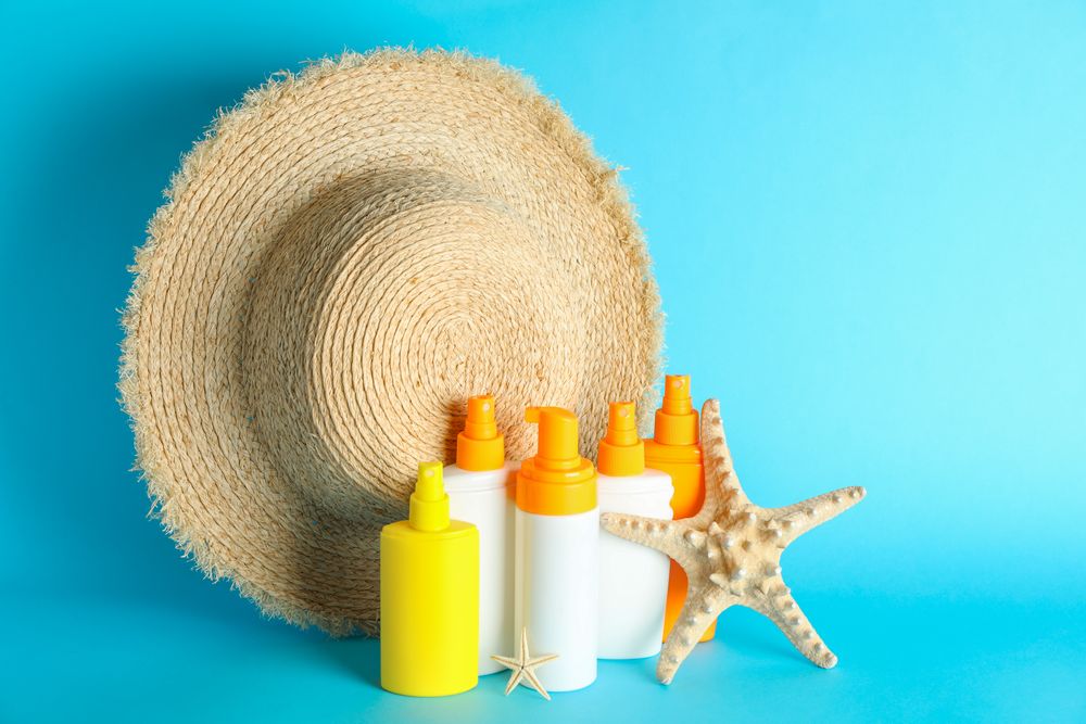 Summer vacation accessories on color background, space for text. Safe tan