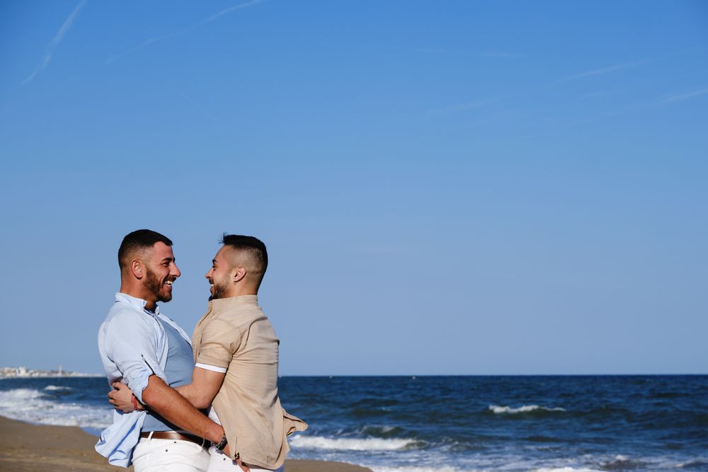 Happy gay couple enjoying and embracing outdoors