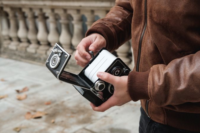 Crop traveler changing film in camera