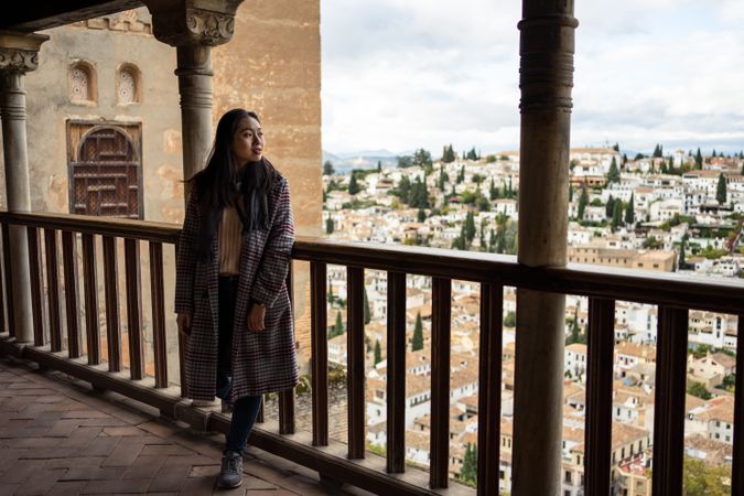 Cheerful woman visiting ancient city