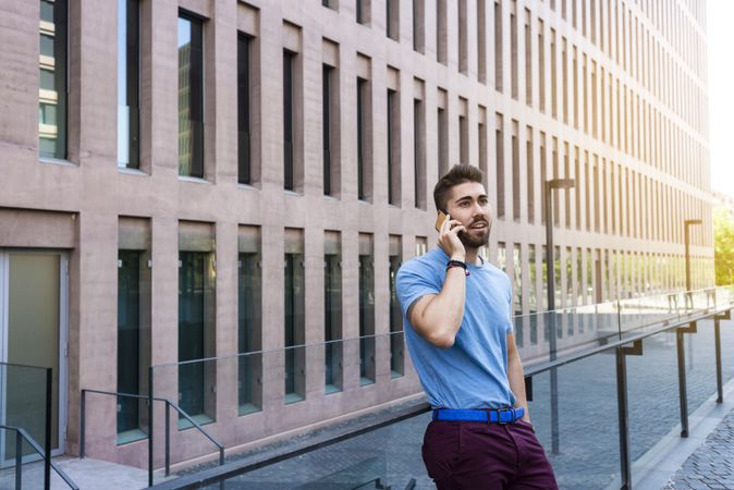 Young bearded man talking on mobile phone