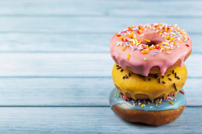 Delicious assorted colorful donuts on the table.