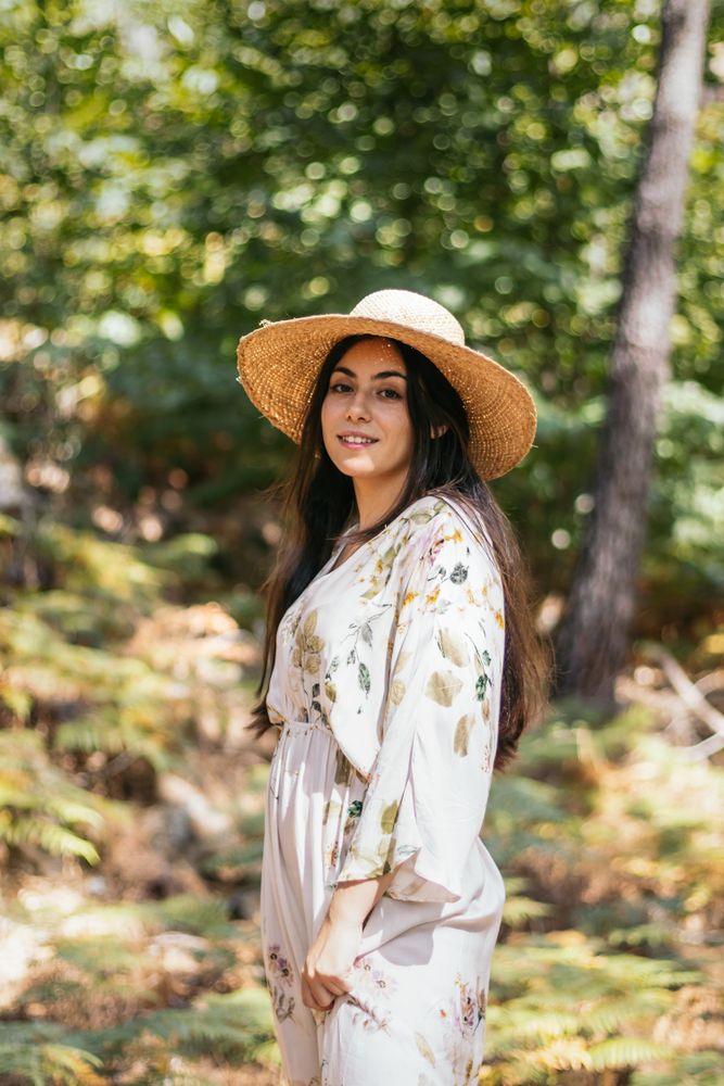 Woman with straw hat in the forest