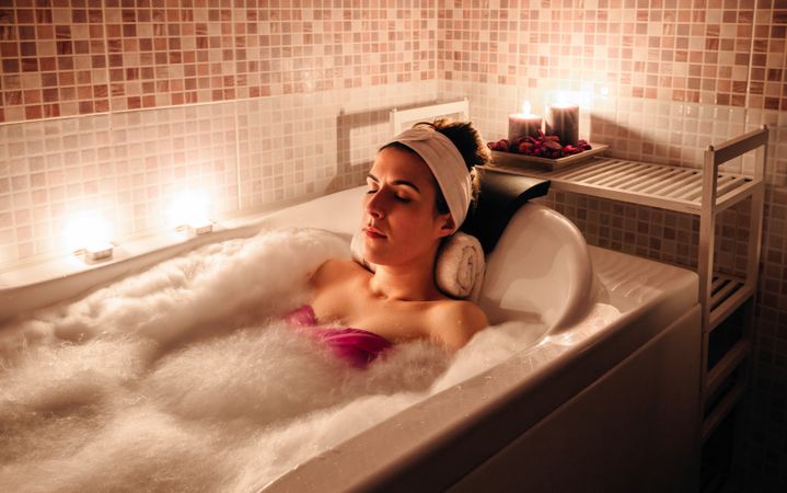 Woman resting in bath in spa