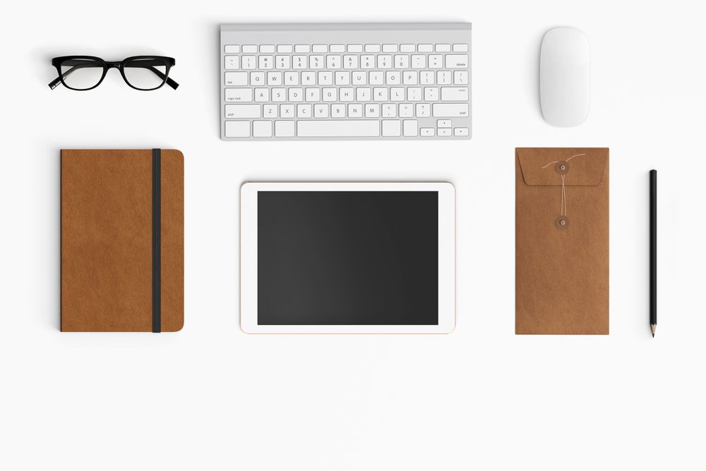 Modern workspace with coffee cup, smartphone, paper, tablet and notebook copy space