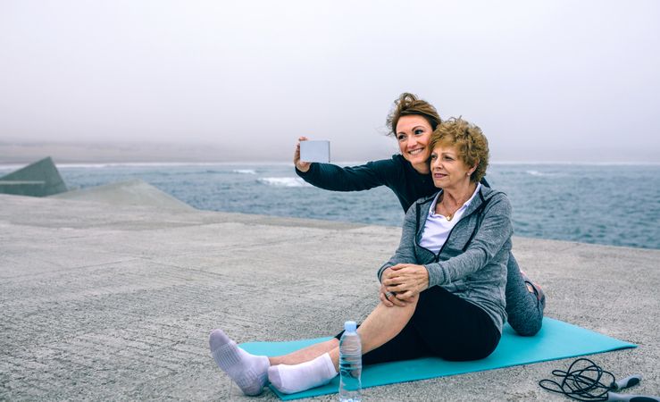 Trainer taking selfie with Mature woman