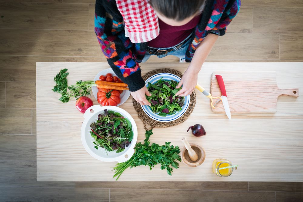 Woman preparing vegetable salad