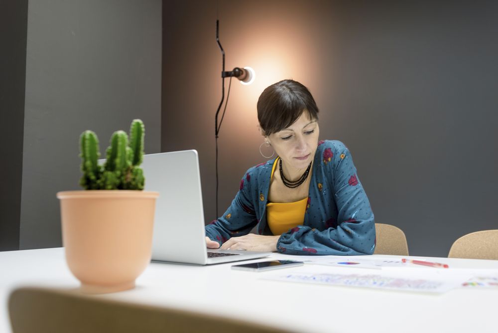 Smiling businesswoman working with laptop