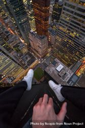 Man sitting on top of building looking down 5p6ZAb