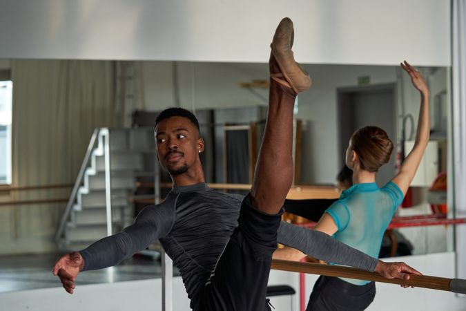 Couple of two dancers in a class doing a training in ballet academy