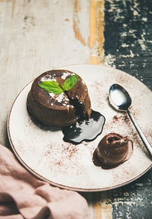 Molten chocolate cake with mint garnish on plate