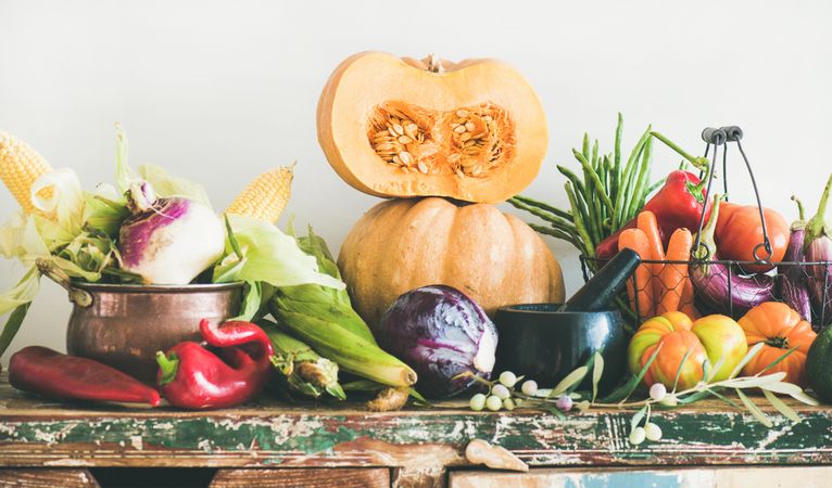 Fresh autumnal produce on kitchen counter, with halved squash