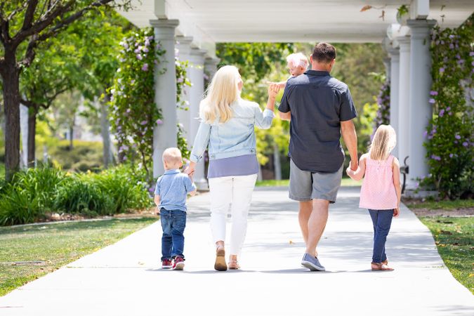 Young Family Taking A Walk In The Park