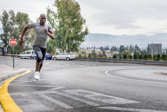 Healthy male jogging on city street