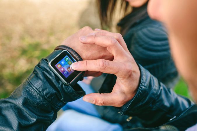Unrecognizable young man using his smartwatch