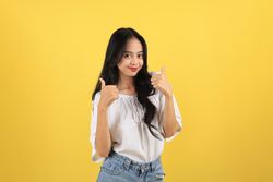 Young Asian Teenager  Women Happy  Smiling to the Camera and Give Two Thumbs Up