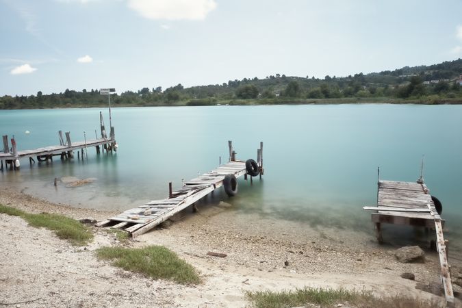 Wooden broken old pier in calm water