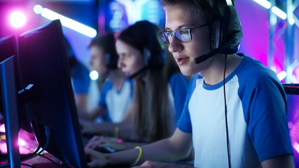 Team of Gamers Play in Multiplayer PC Video Game on a eSport Tournament.