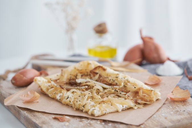 Appetizing onion tart on chopping board