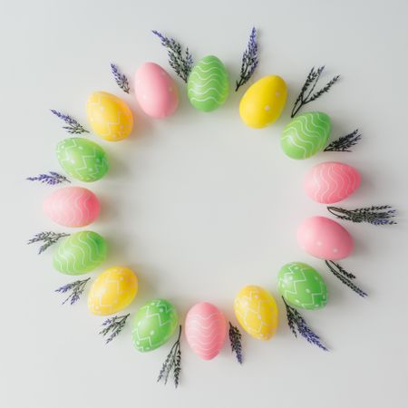Pastel Easter eggs in circle on light background