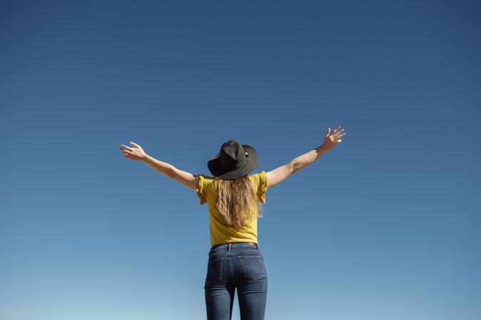 Woman standing against blue sky