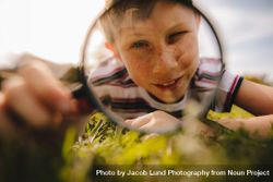 Cute boy exploring with magnifying glass 5argQ4