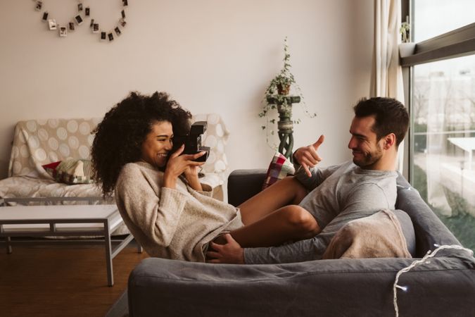 Black woman taking picture of boyfriend