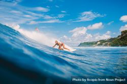 Woman surfing on sea waves 5oOzG5