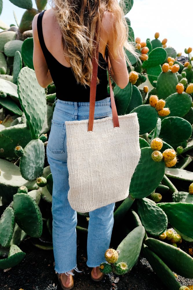 Woman standing among large prickly pear plant