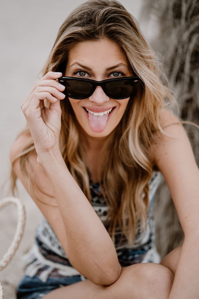 Portrait of young cheerful woman with sunglasses
