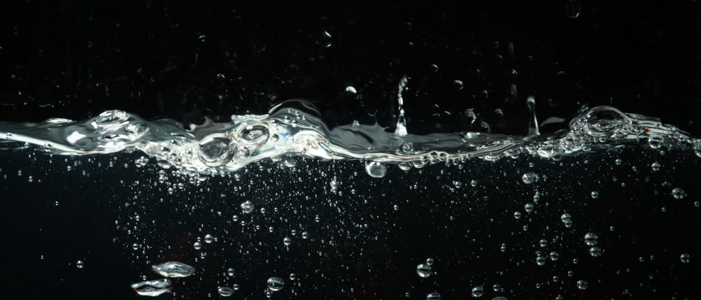 Side view of fresh water splashing on day background