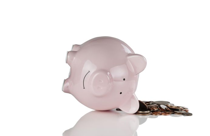 Financial bad times with piggy bank and coins on blank background