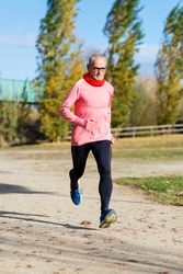 Older male sprinting in park