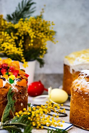 Easter food concept with traditional cake and colorful eggs decorated with spring flowers