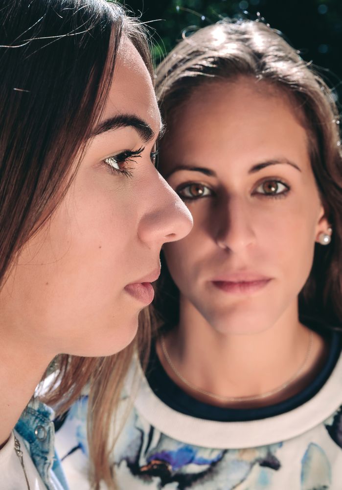 Two serious women with focus on profile woman