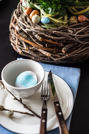 Easter table setting with large nest centerpiece with decorative eggs