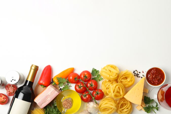 Composition with pasta and ingredients for cooking on plain background, top view