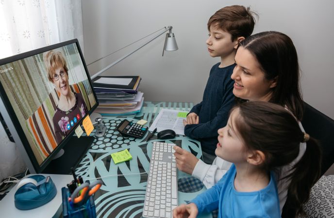 Family talking on video call with grandmother