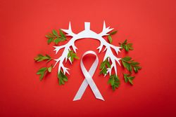 Lung bronchus on red background with ribbon and foliage