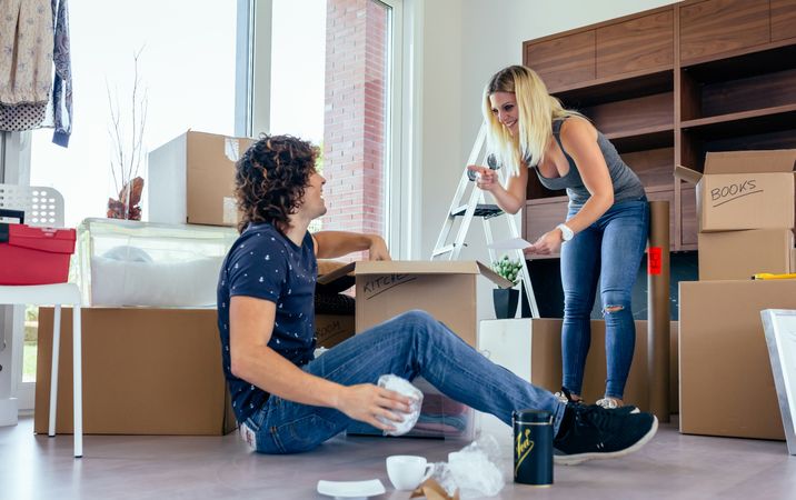 Couple unpacking moving boxes