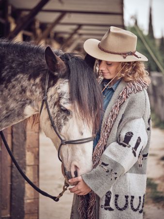 Woman near horse in paddock