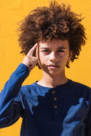 Pensive Black boy with Afro hairstyle