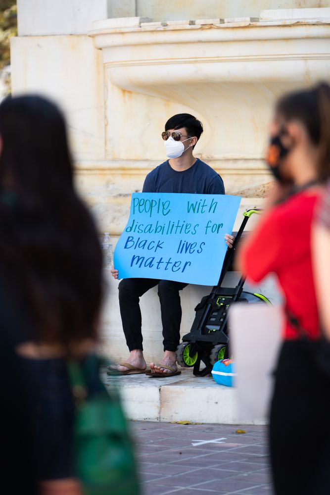 Los Angeles, CA, USA — June 16th, 2020: man sitting with homemade sign at protest rally