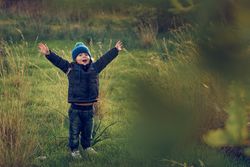 Happy boy on grassy field