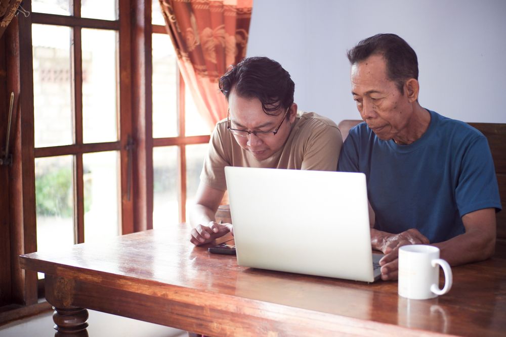 Father and son with laptop
